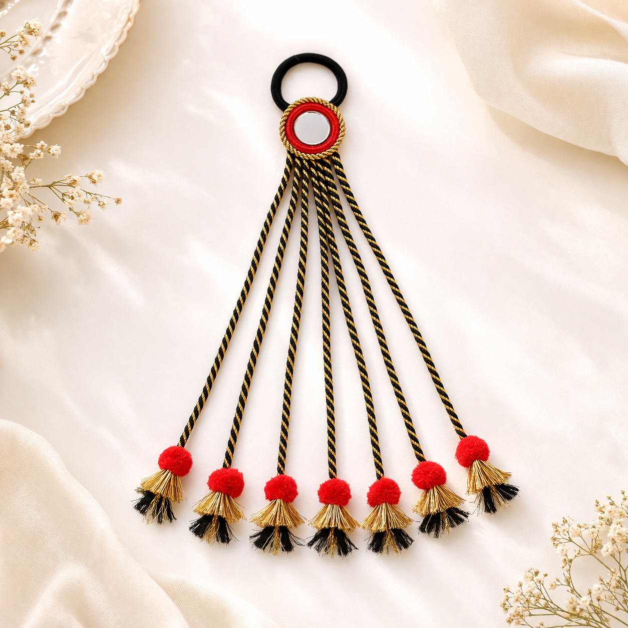 Suwasna Black and Golden Boho Style Tassel Hair Tie With Red Colour Pom Pom And Golden Gota Flowers | Festival, Garba & Casual Hair Accessory Design
